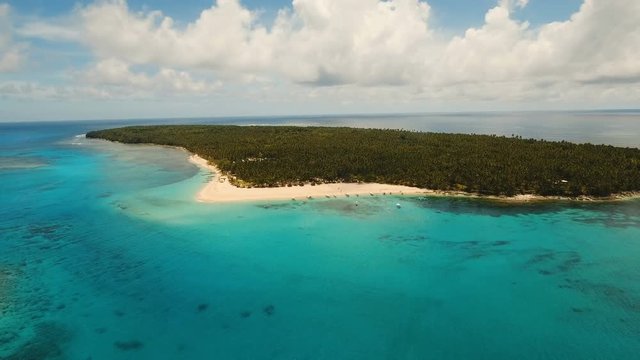 Aerial view of beautiful tropical island Daco with white sand beach. View of a nice tropical beach from the air. Beautiful sky, sea, resort. Seascape: Ocean and beautiful beach paradise. Philippines