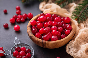 Fresh ripe cranberry in wooden bowl