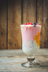 cocktail with berries and chia seeds are layered