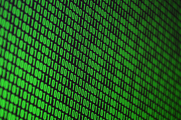 An image of a binary code made up of a set of green digits on a black background