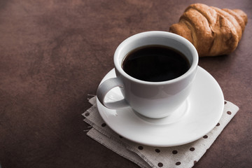 croissant with a cup of coffee