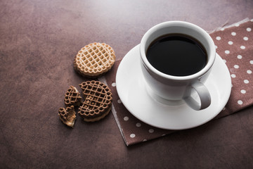 white cup of coffee with chocolate cookies