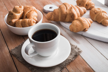 aroma cup of coffee with sweet croissant