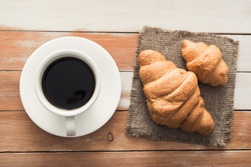 aroma cup of coffee with sweet croissant