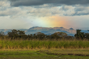 rainbow over the mountains at sunset