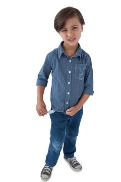 Boy standing with empty pockets against white background