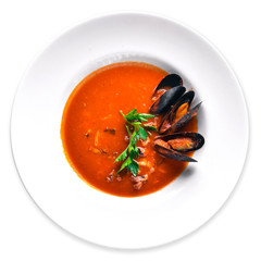 Tomato and seafood creamy soup with mussels.