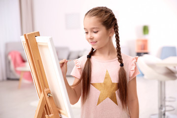 Little girl painting at home