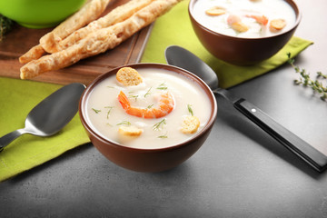 Bowl with yummy shrimp cream soup on table