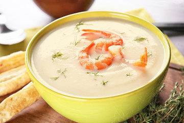 Bowl with yummy shrimp cream soup on table, closeup