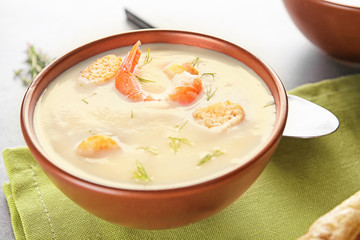 Bowl with yummy shrimp cream soup on table
