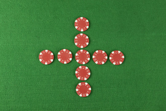 red poker chips above green cloth