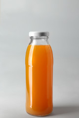 Bottle with juice on light background
