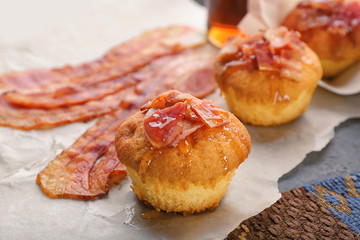 Tasty bacon muffin on table