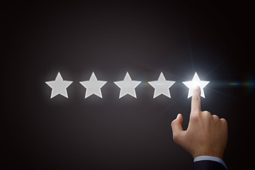 Businessman pointing five star to increase the rating.