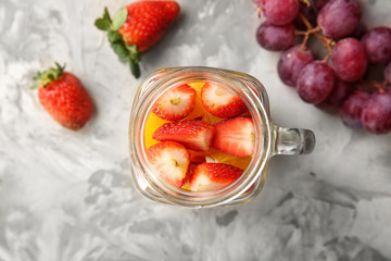Delicious fruit salad in mason jar on table