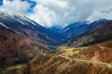 Panoramic view on snow winter spring mountains and cloud sky. Caucasus Mountains. Svaneti region of Georgia.