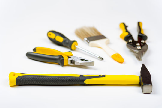 A set of different yellow hand tools 