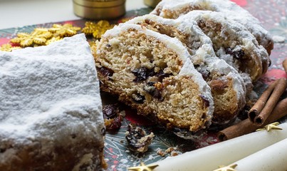 Christmas shtollen on a green background. Traditional German dessert