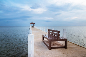 Pier with wooden benches at the sea