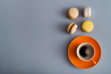 coffee cup with sweet colorful macaroons