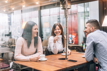 Group of friends having good time in cafe.