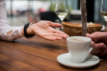 Closeup conversation of two people in cafe.