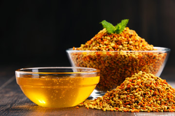 Bowls with bee pollen and honey on kitchen table