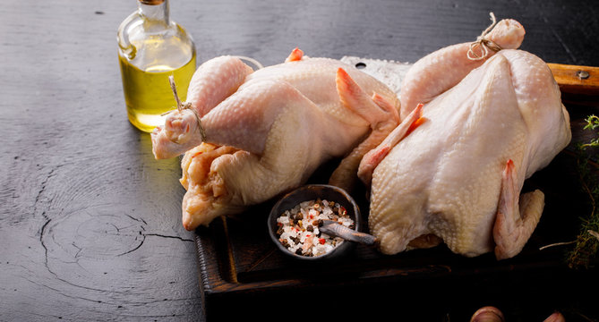 Whole Raw Chicken with Herbs and Spices on Wooden Cutting Board Food Ingredient Cooking Background Bird Meat