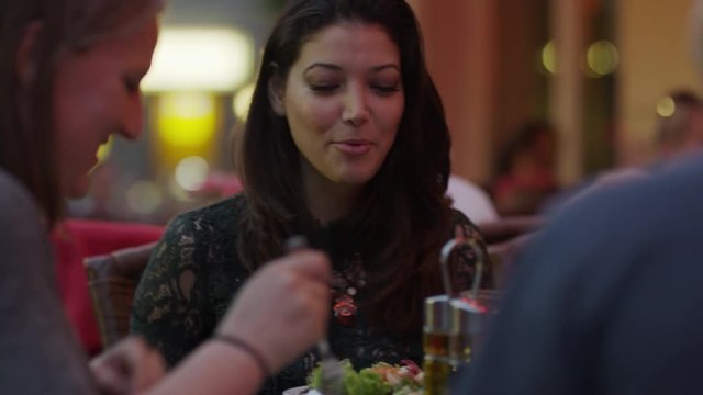 Close up of friends eating at restaurant / Berlin, Germany