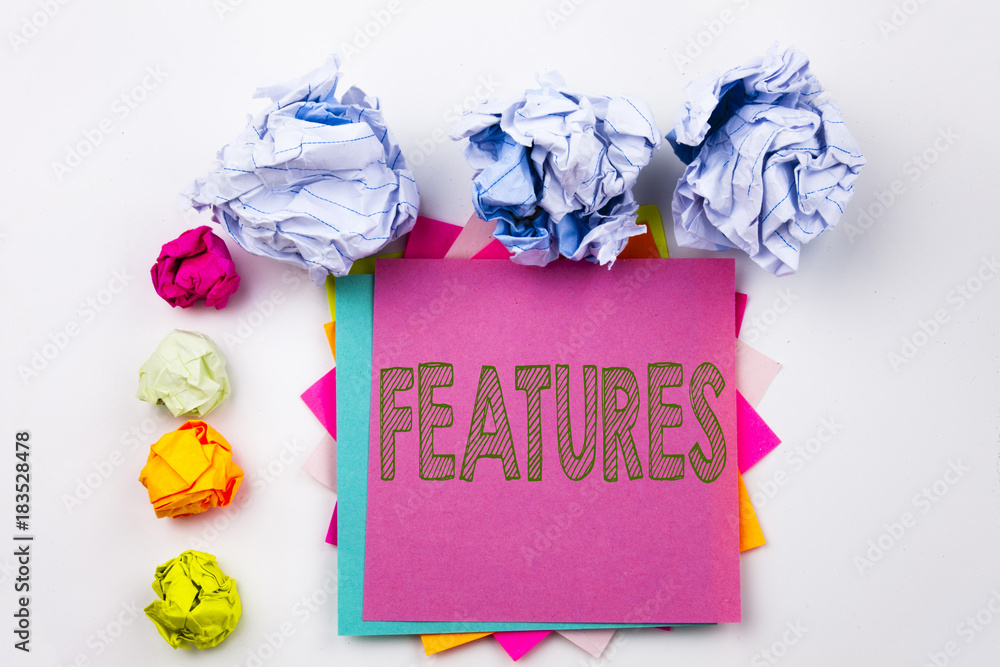 Poster writing text showing features written on sticky note in office with screw paper balls. business conc