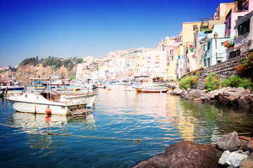 Fototapeta na wymiar Procida island colorful town with harbor at summer, Italy, retro toned