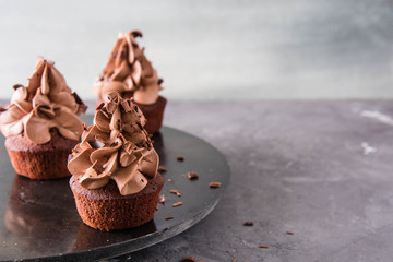Chocolate cupcakes on a dark background.