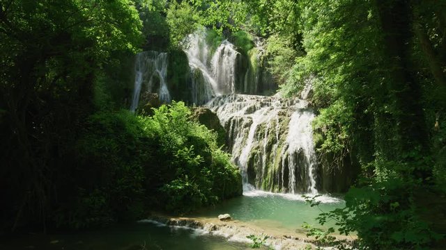 Wide shot of distant waterfalls in forest / Krushuna, Bulgaria