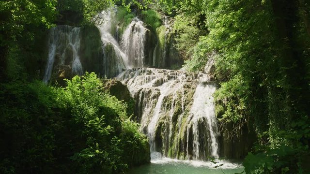 Wide shot of distant waterfalls in forest / Krushuna, Bulgaria