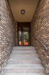 Exterior staircase, brick wall and front door