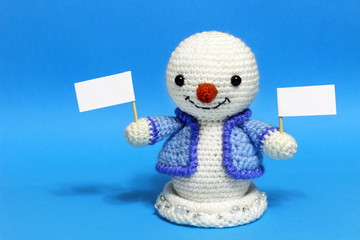 snowman with tablets in both hands