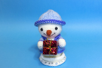 snowman with gift box in hands