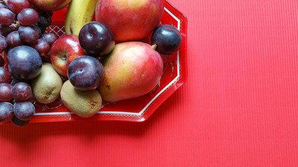 Fruits background.Healthy eating concept. Red background