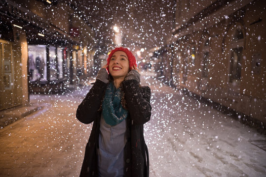 young woman enjoying on snowy night 