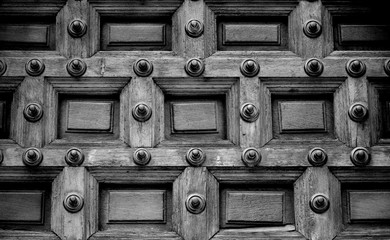 Close up of an Antique door allowing Access to an Ancient Church in Black and White