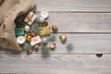 Christmas decorations in a sack on a white wooden surface. Top view
