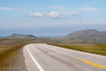 The road is far away against the background of stony hills