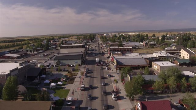Aerial view of cars driving on street in small town / Driggs, Idaho, United States