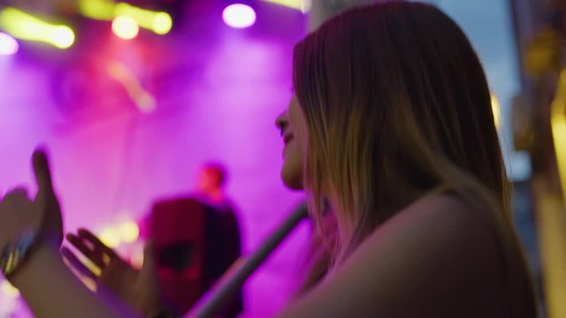 Close up low angle shot of woman dancing at concert / Plovdiv, Bulgaria
