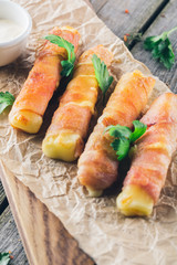 Сream cheese which is wrapped up in bacon