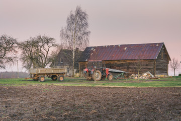 Fototapeta premium Farm in perfect weather with sunrise over countryside. Views on farm buildings and agrictulture technique.