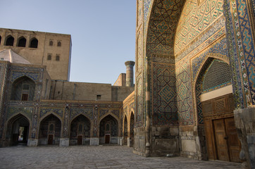 Fototapeta na wymiar Morning sun in wall of madrasas with traditional mosaic ornament . Samarkand, Uzbekistan