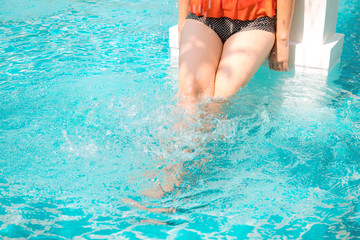 Woman 's leg enjoy relaxing in the pool