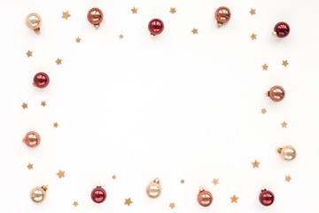 Christmas pastel, red, pearl bells, golden stars on white background, top view, flat lay